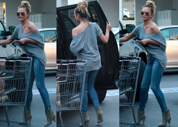 Chrissy Teigen maneuvers around a shopping cart and opens the door of a car on a grocery run
