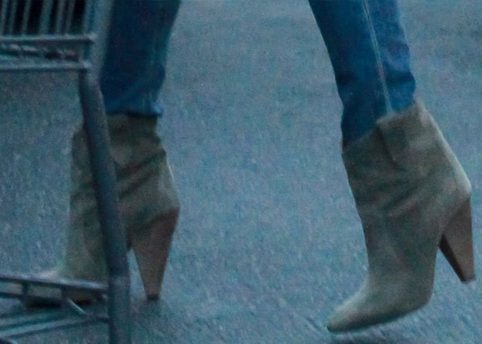 Chrissy Teigen wears Isabel Marant Roxann booties on her feet during a trip to the grocery store