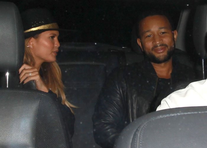 Chrissy Teigen and John Legend are spotted sharing a quiet moment in the backseat as they arrive in style for their date night
