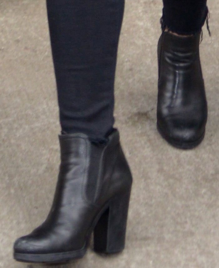 Demi Lovato wears a pair of chunky black booties from Prada on her feet