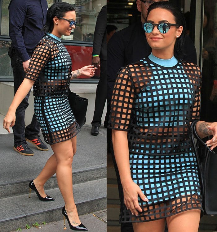 Demi Lovato shows off her slicked-back hairstyle as she navigates down a set of stairs