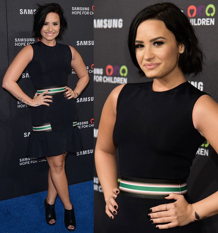 Demi Lovato shows off her short hair, tattoos and black manicure as she confidently poses with her hands on her hips