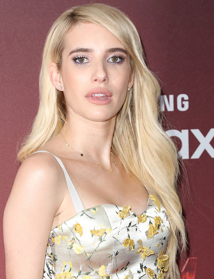 Emma Roberts throws a sultry look and shows off her long blonde hair at the "Scream Queens" premiere