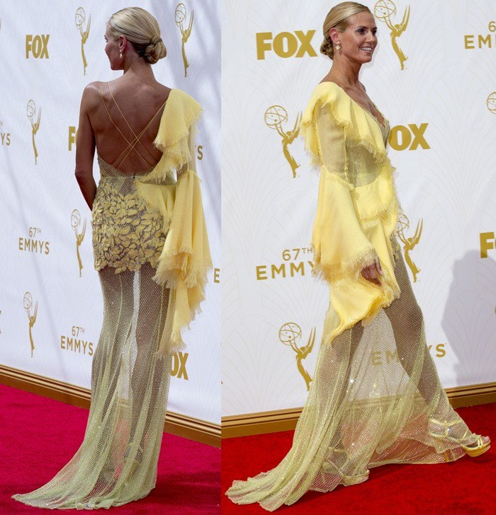 Heidi Klum struts the red carpet at the Emmys in a horrible yellow Versace gown
