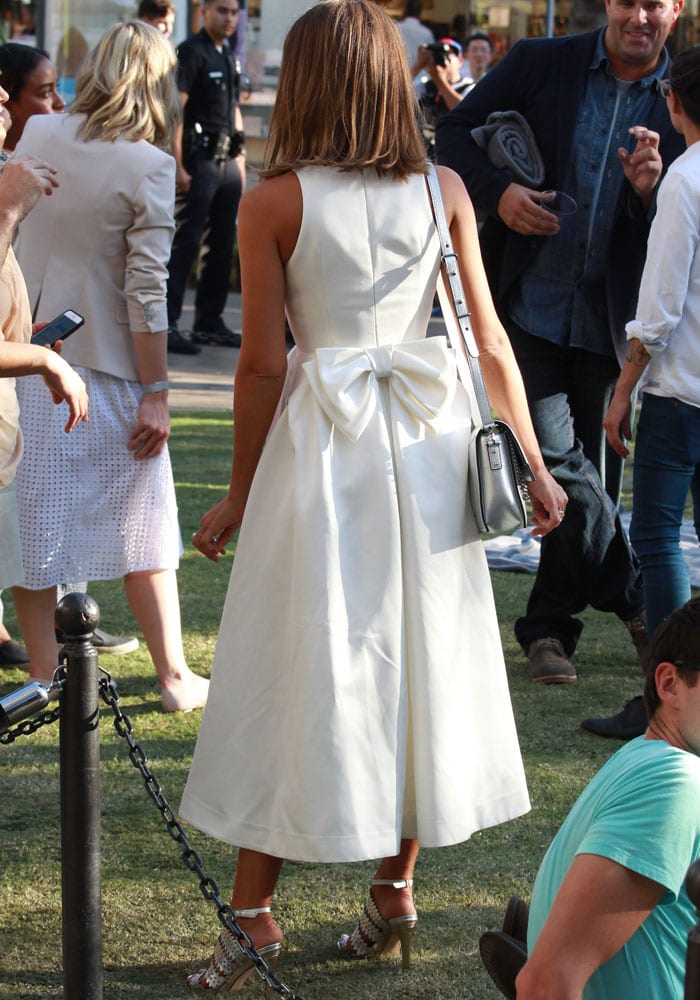 Jessica Alba shows off her straight hair and the bow on the back of her white dress