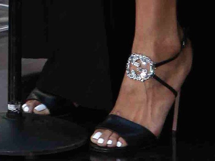 Jordin Sparks shows off her white pedicure and the sparkling Gucci logo on her sparkling GG logo sandals