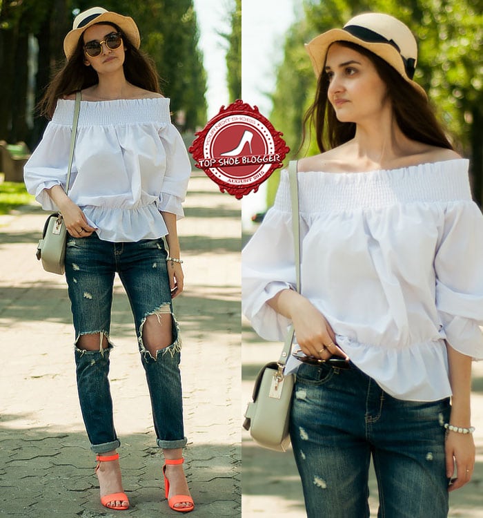 Karina in casual ripped jeans and a white breezy off-the-shoulder top