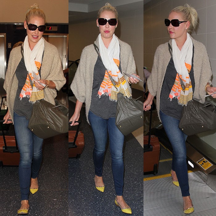 Katherine Heigl tops her airport ensemble with a neutral cardigan and carries a gray duffel bag