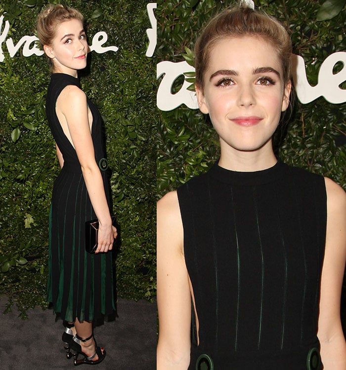 Kiernan Shipka smiles and poses in a forest green and black dress