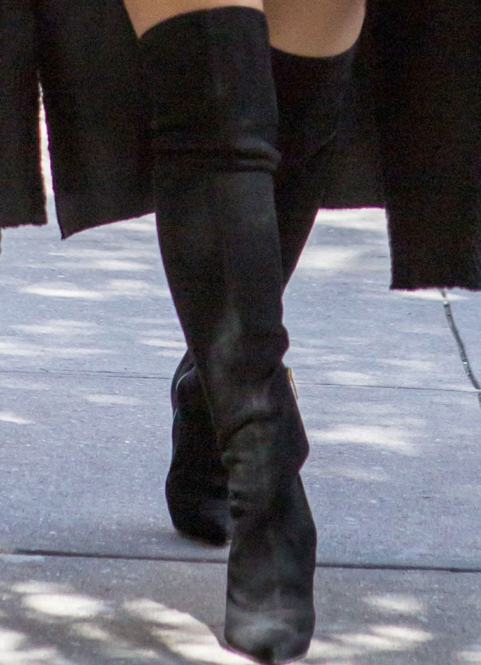 Kim dons her signature thigh-high boots look with a little help from Sergio Rossi