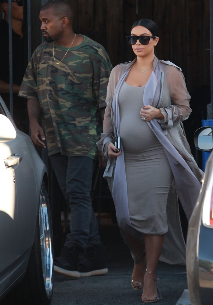Kim Kardashian and Kanye West walk toward their Rolls Royce
