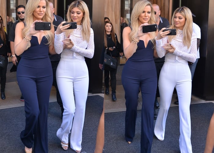 Khloé Kardashian and Kylie Jenner stroll out of their hotel in navy-and-white outfits while recording videos on their cellphones