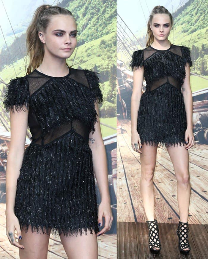 Cara Delevingne looked stunning in a black Burberry mini dress featuring feather-like accents and edgy mesh inserts