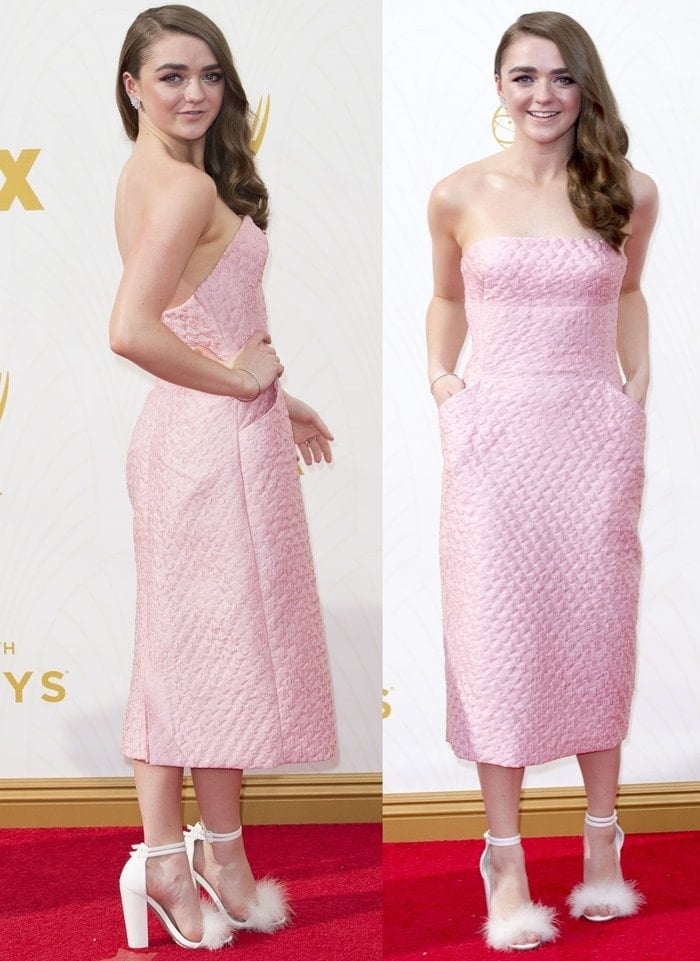 Maisie Williams smiles on the red carpet in a blush pink midi dress
