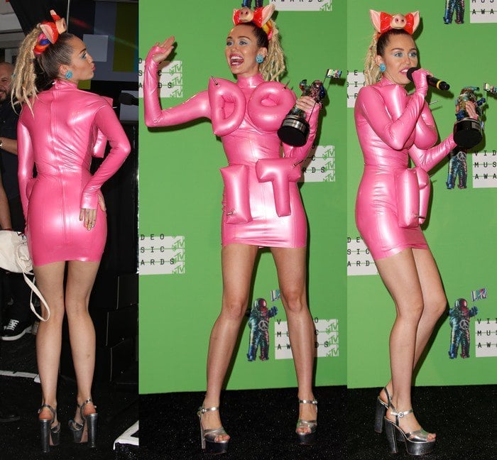 Miley Cyrus shows off her backside and her long slim legs as she poses in a pink inflatable dress