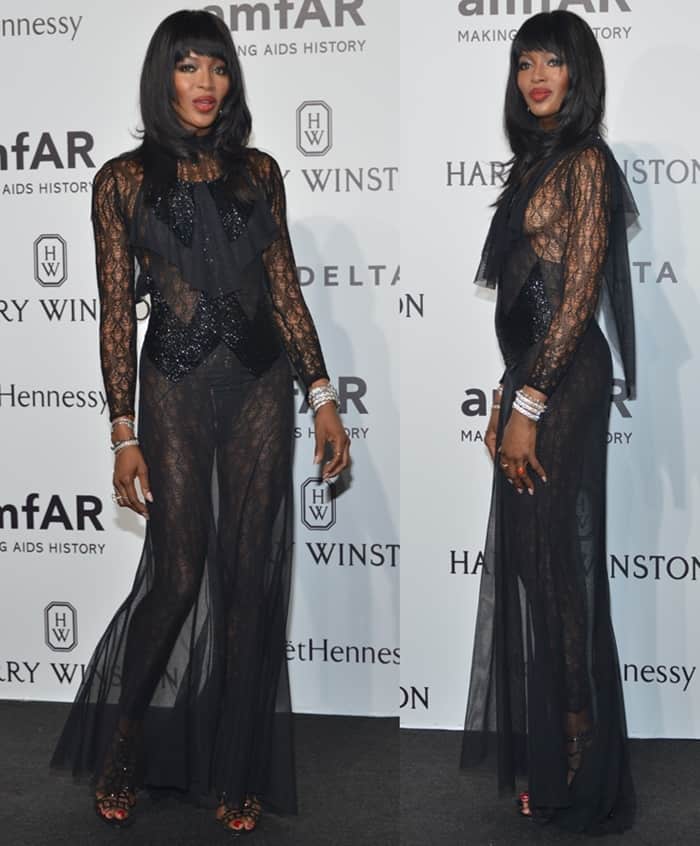 Naomi Campbell brought high glamour to the amfAR gala in Milan in a classic black lace gown that swept the floor, exuding elegance and sophistication