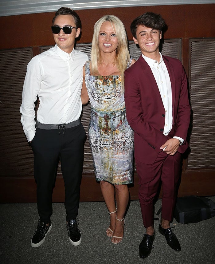 Pamela Anderson radiates elegance in a paint-splatter-effect cocktail dress and strappy nude heels, posing with her dapper sons, Brandon Thomas Lee and Dylan Jagger Lee, at the Mercy for Animals Hidden Heroes Gala in Culver City, California, on August 29, 2015