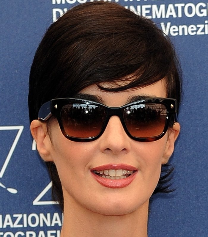 Paz Vega sports a chic, short pixie cut paired with classic black sunglasses