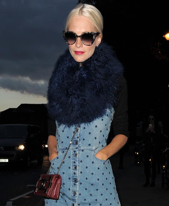 Poppy Delevingne exudes effortless style at the House of Holland Spring/Summer 2016 show during London Fashion Week in London, England, on September 19, 2015, turning heads with her bold accessories and chic denim ensemble