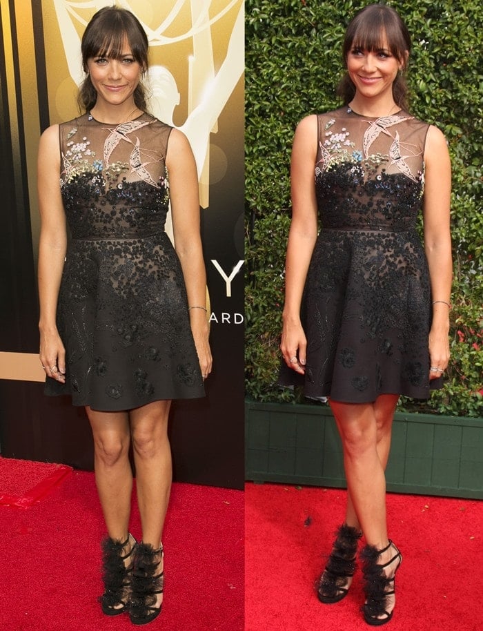 Rashida Jones poses and smiles on the red carpet in a black dress from Valentino's Resort 2016 collection