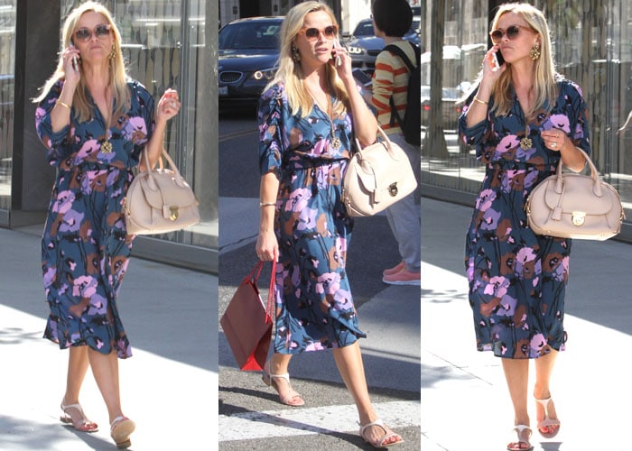 Reese Witherspoon chats on her cellphone as she goes shopping at Cartier in a dress from her own line, Draper James