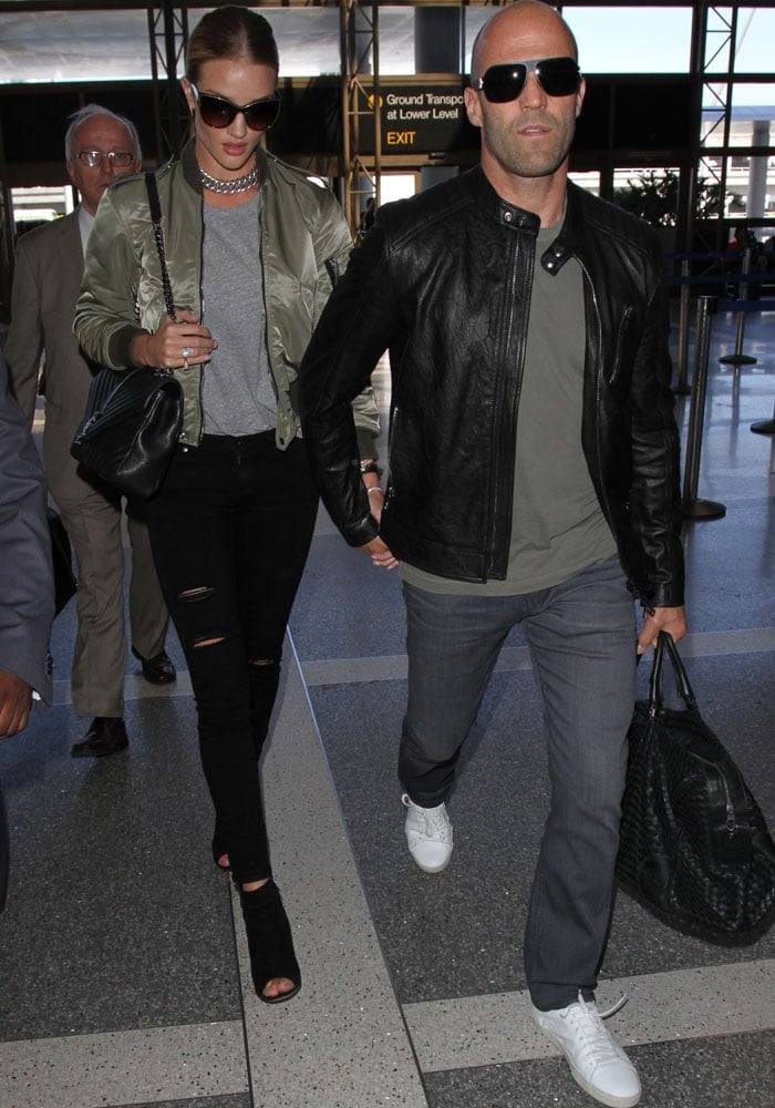 Rosie Huntington-Whiteley and Jason Statham make their way through LAX in matching casual outfits