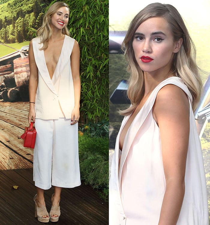 Suki Waterhouse shows off a lot of cleavage and red lipstick in a Camilla and Marc ensemble