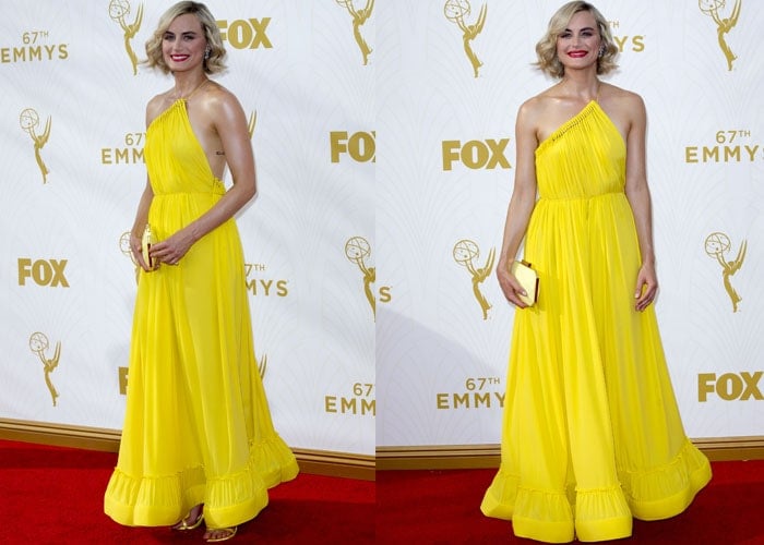 Taylor Schilling's blonde hair matches the gold backdrop of the Emmy Awards and her yellow curtain-like dress