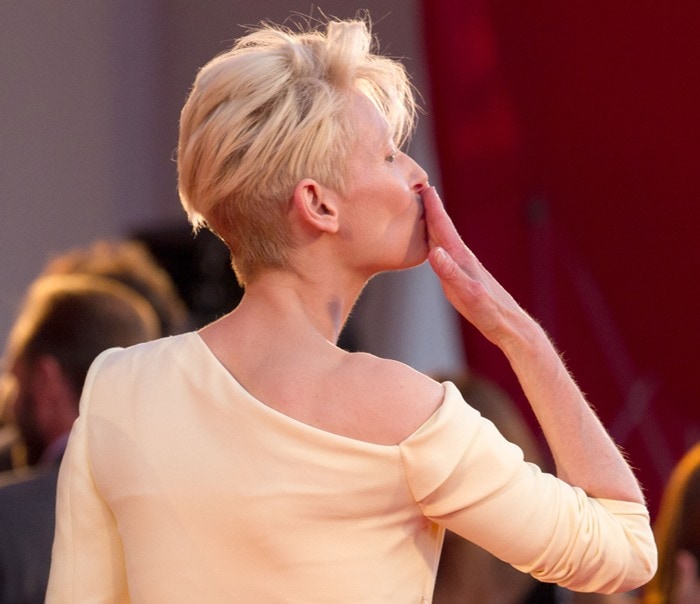 Tilda Swinton blows a kiss from the carpet at the premiere of her new film