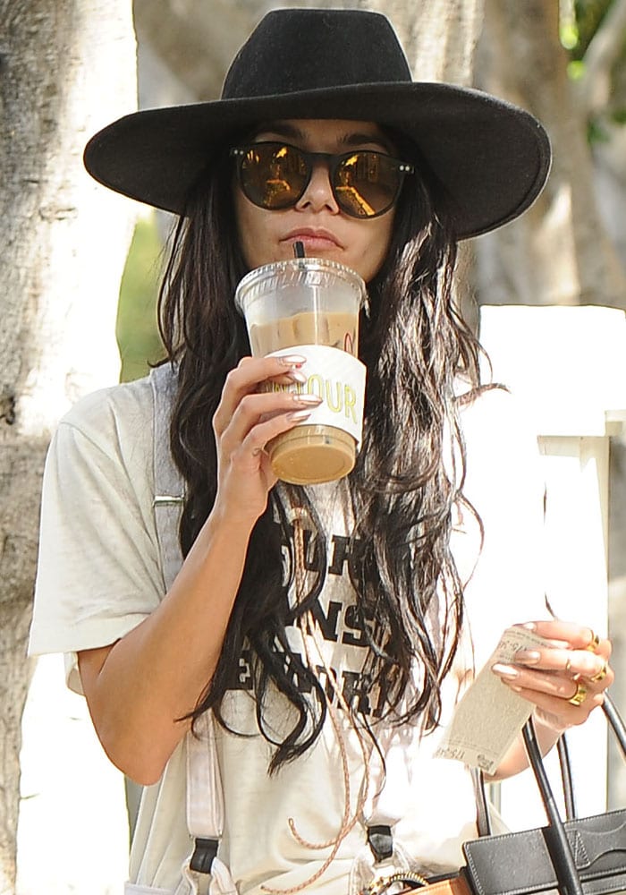 Vanessa Hudgens rocks a boho hat from Free People while waiting patiently for the valet in Los Angeles