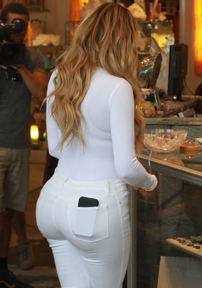 Khloe Kardashian flaunts her backside in a pair of skintight white jeans
