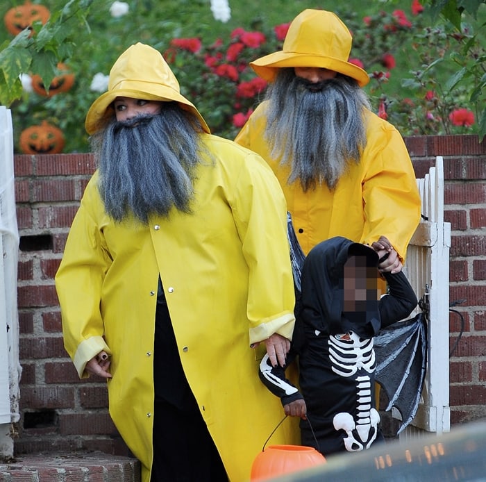 Wearing bright yellow raincoat costumes with manly long beards, Sandra Bullock went trick or treating with good friend Melissa McCarthy and Sandra's son Louis Bardo Bullock in a skeleton costume