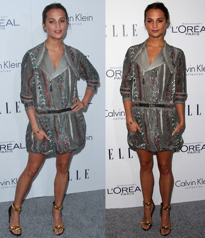 Alicia Vikander stuns in a metallic-patterned Louis Vuitton mini dress paired with statement gold ankle-strap heels