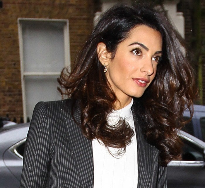 Amal Clooney wears her hair down as she heads to a press conference in London