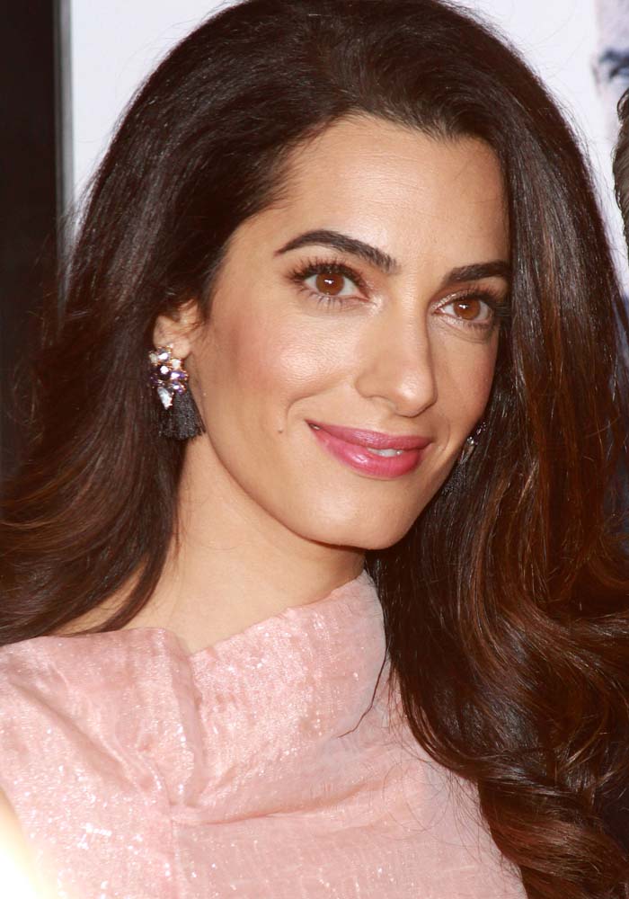 Amal Clooney wears her dark hair down at the premiere of "Our Brand is Crisis"