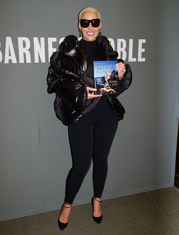Amber Rose poses for photos with her new book "How to Be a Bad Bitch"