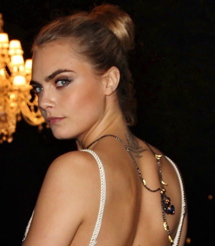 Cara Delevingne shows off her De Grisogono statement necklace featuring a little chimpanzee set with 771 black diamonds