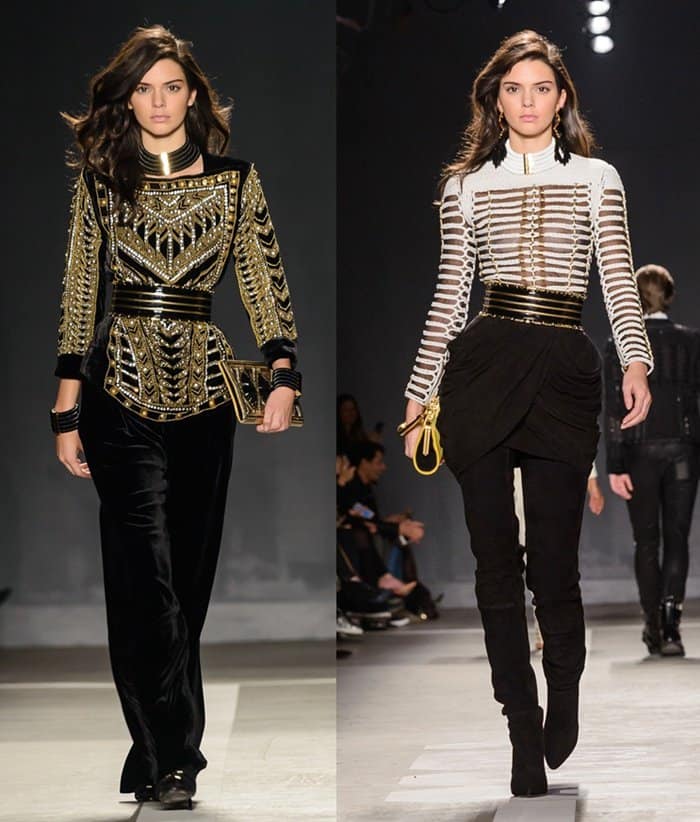 Kendall Jenner commands the runway in two striking Balmain x H&M ensembles featuring intricate gold detailing and bold, structured silhouettes