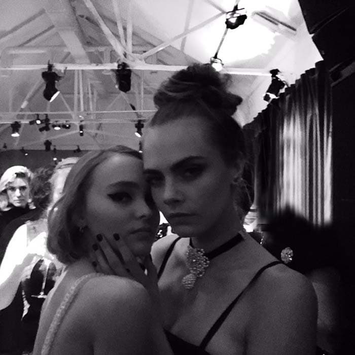 Cara Delevingne poses with Lily-Rose Depp at the exhibit opening of Mademoiselle Privé for Chanel in London