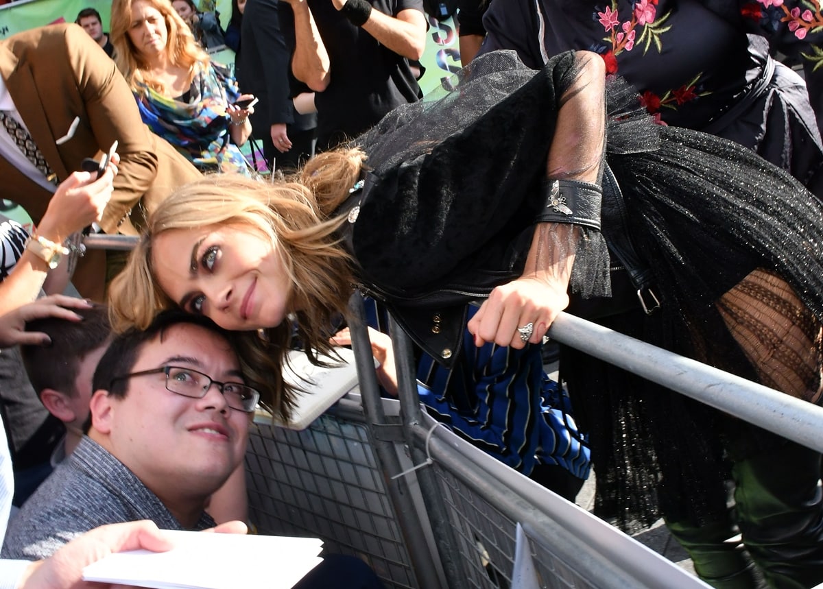 Cara Delevingne meets a fan at the European Premiere of "Suicide Squad"