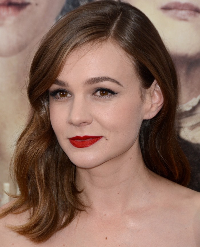 Carey Mulligan radiates elegance with striking red lipstick contrasting her fair skin at the "Suffragette" movie premiere in New York City, October 12, 2015