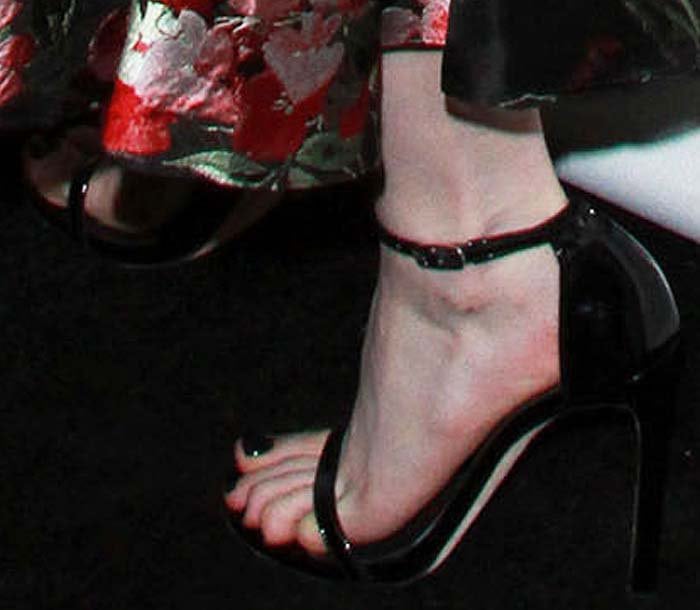 Emma Roberts shows off her feet in black patent sandals