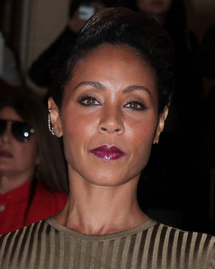 Jada Pinkett Smith showcases a sleek updo and bold makeup paired with a statement ear cuff