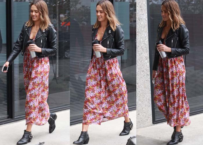 Jessica Alba holds a coffee in one hand and her phone in the other as she runs errands in a floral dress