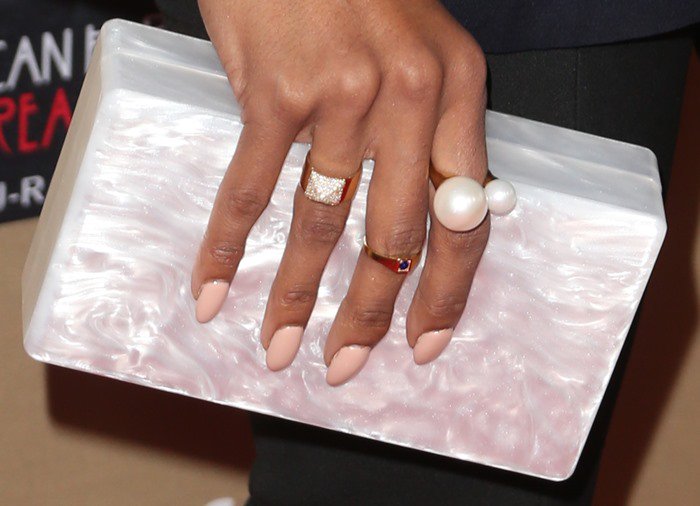 Kat Graham toting an Edie Parker clutch