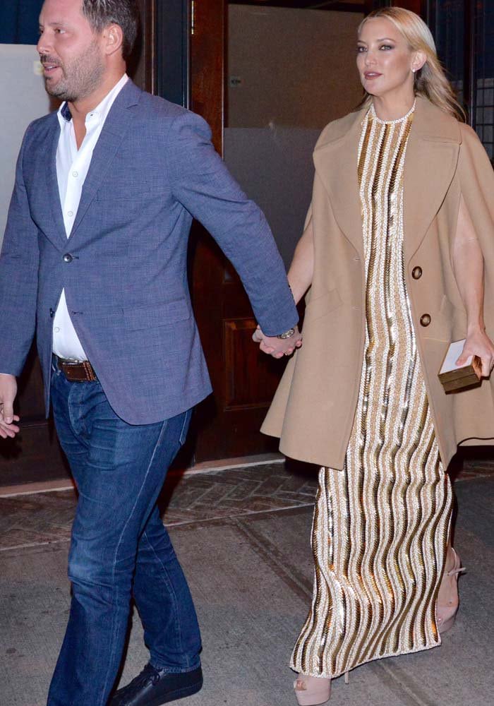 Kate Hudson holds hands with her agent Michael Kives as she heads to her car after a movie premiere