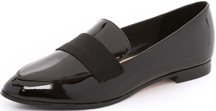 A grosgrain-ribbon accent crosses the vamp of a pointy-toe loafer for a feminine finish