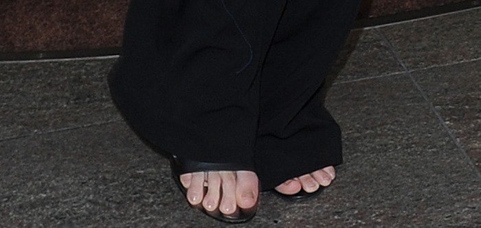 Kendall Jenner's weird feet peeking out from beneath the flared hems of her long black pants