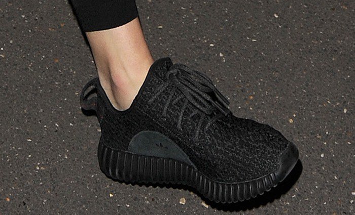 Kendall Jenner completes her airport look with a pair of "Yeezy Boost 350" sneakers on her feet