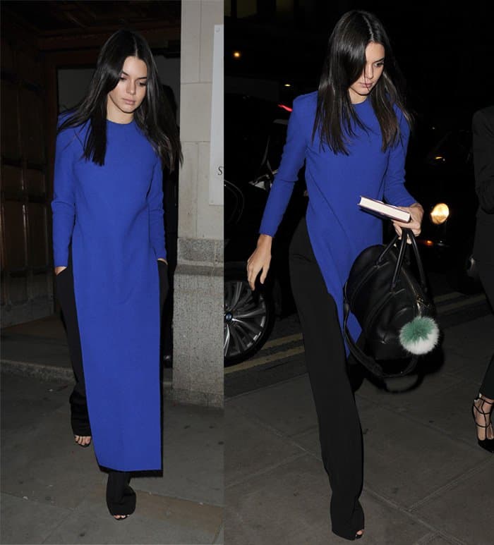 Kendall Jenner stuns in a vibrant blue asymmetrical top paired with sleek black wide-leg pants, effortlessly combining elegance with modern style